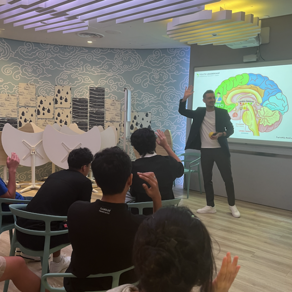 Dr. Bjoern Lindemann leading an “Understanding Self and Others” and Emotional Regulation session at the Youth Leadership & Communication Camp, with youth participants actively engaged in discussion and activities.